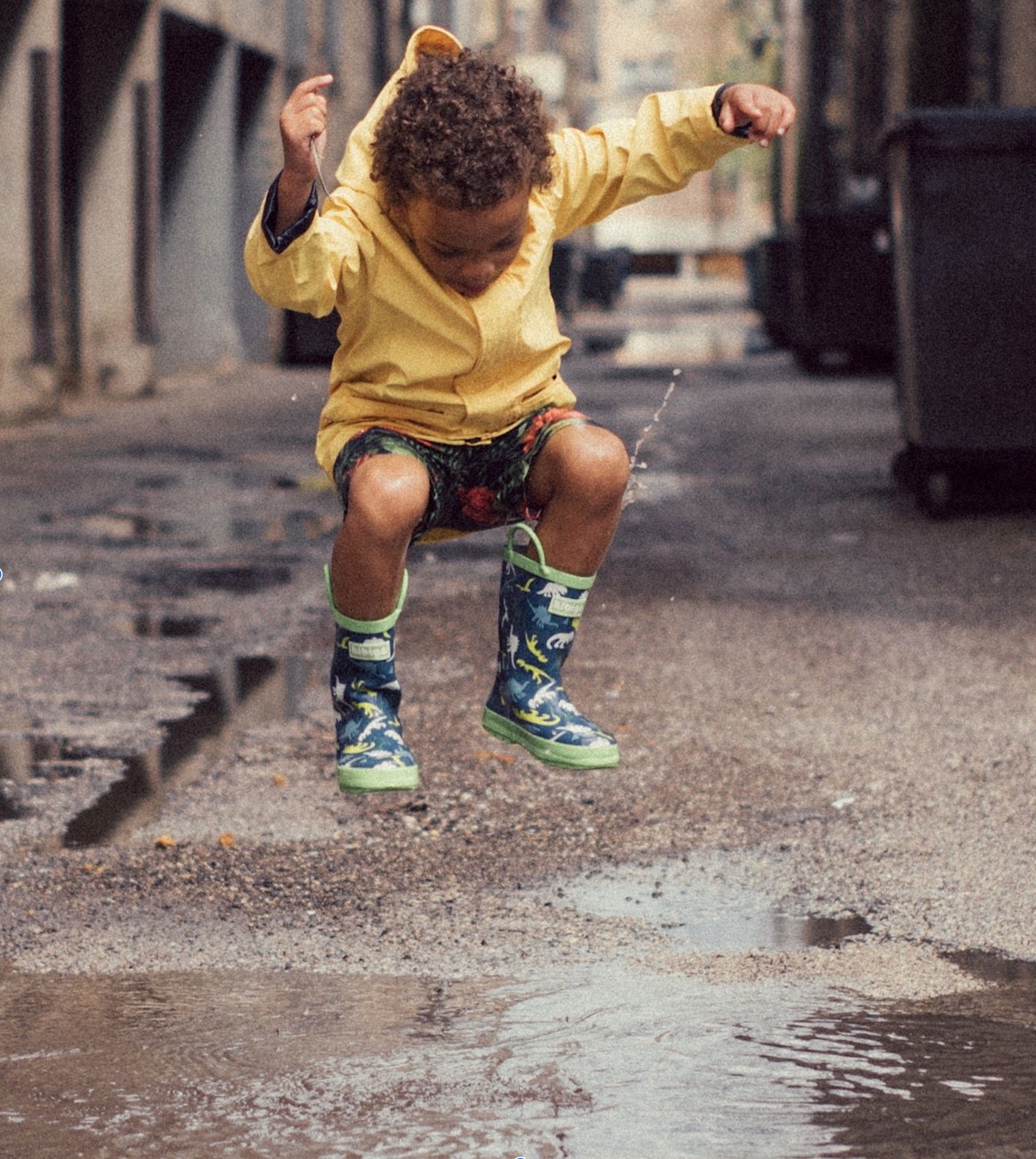 Child jumping in a puddle
